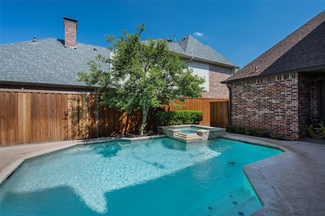 view of swimming pool with an in ground hot tub