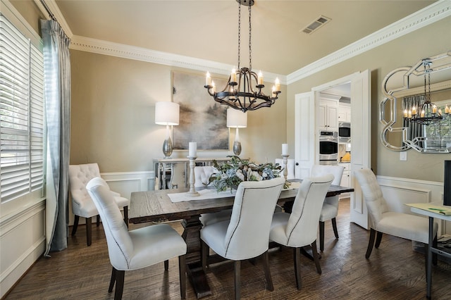 dining space with an inviting chandelier, dark wood-type flooring, and ornamental molding