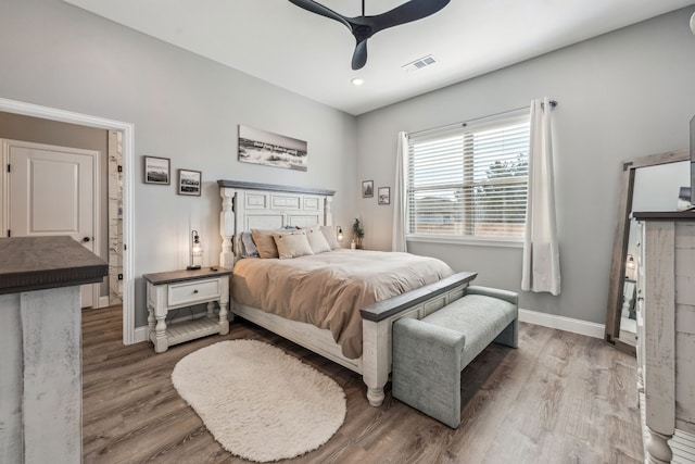 bedroom with hardwood / wood-style flooring and ceiling fan