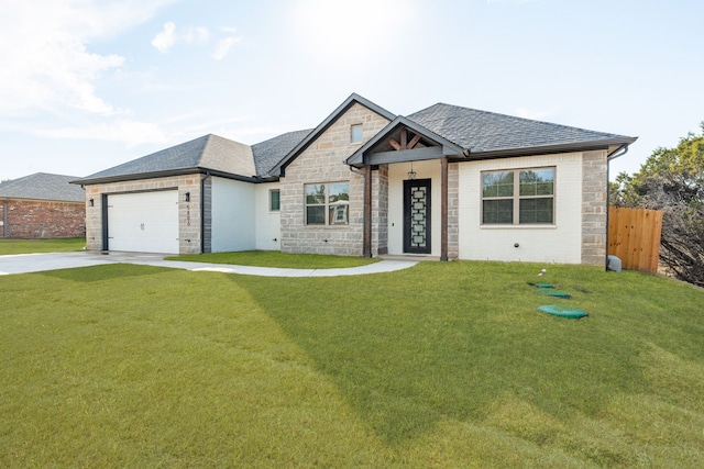 view of front of house with a garage and a front yard