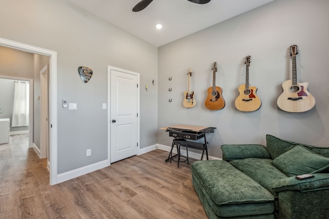 sitting room with hardwood / wood-style flooring and ceiling fan