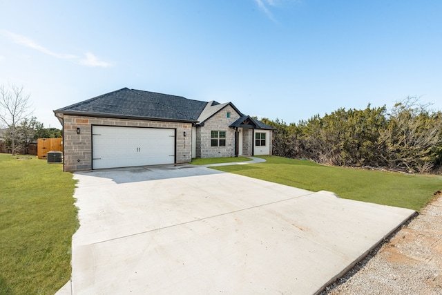 view of front of home with a garage, a front lawn, and central air condition unit