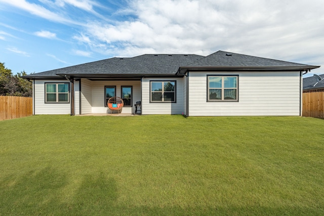 rear view of house with a yard and a patio area