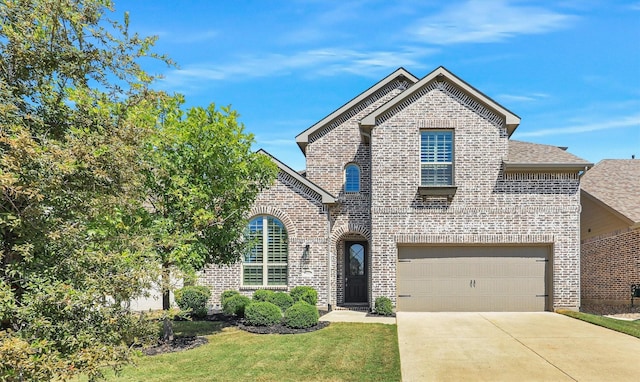 view of front of home with a garage and a front yard