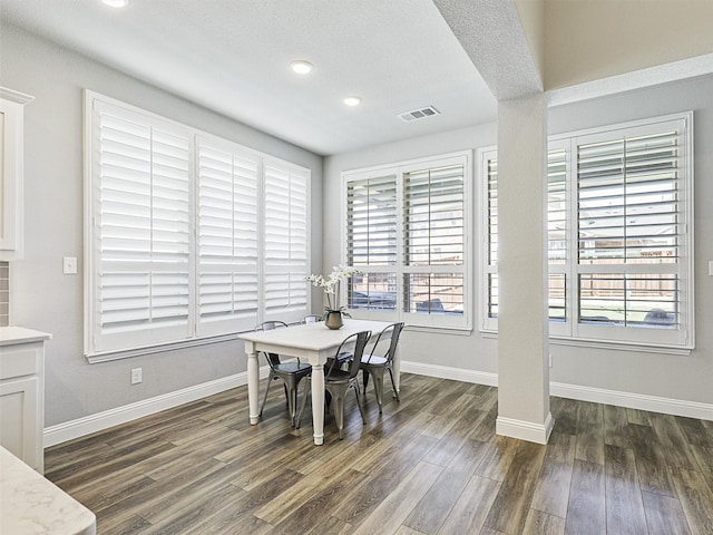 dining area with dark hardwood / wood-style floors