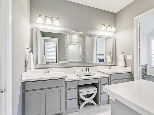 bathroom with vanity and a shower