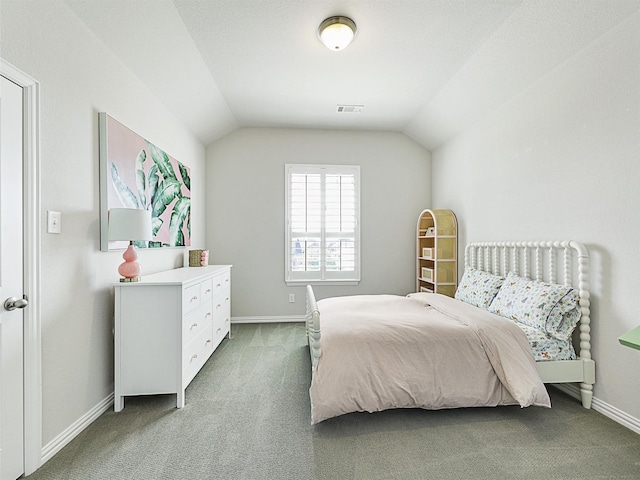 bedroom with vaulted ceiling and dark carpet