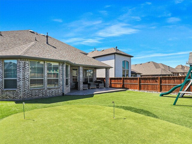 view of yard featuring a patio area and a playground