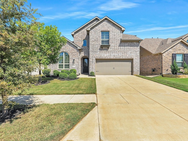 view of front of house with a garage and a front yard