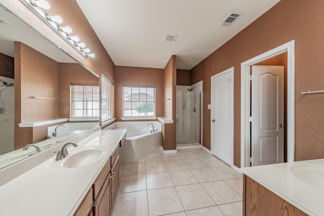 bathroom featuring tile patterned floors, vanity, and shower with separate bathtub