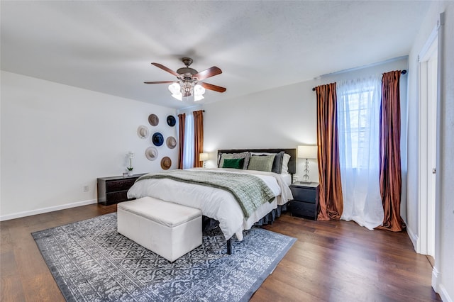 bedroom with ceiling fan and dark hardwood / wood-style floors