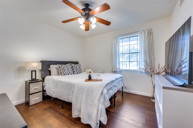 bedroom with dark hardwood / wood-style floors and ceiling fan