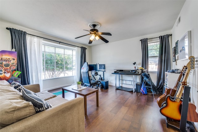 living room featuring ceiling fan and dark hardwood / wood-style flooring