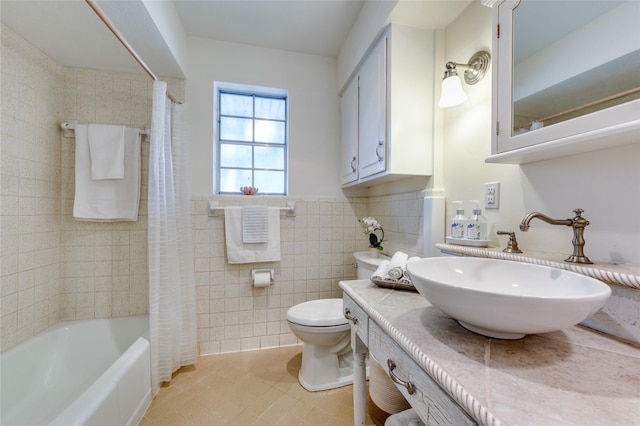 full bathroom featuring shower / tub combo with curtain, tile patterned floors, toilet, tile walls, and vanity