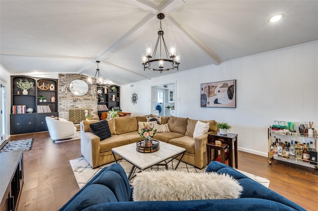 living room with lofted ceiling with beams, a notable chandelier, hardwood / wood-style floors, and built in features