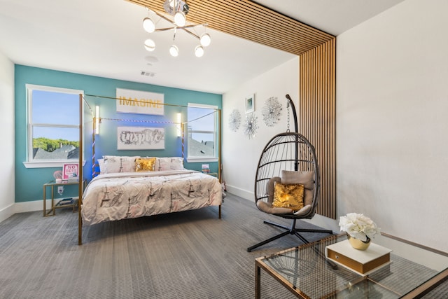 bedroom featuring carpet and a notable chandelier