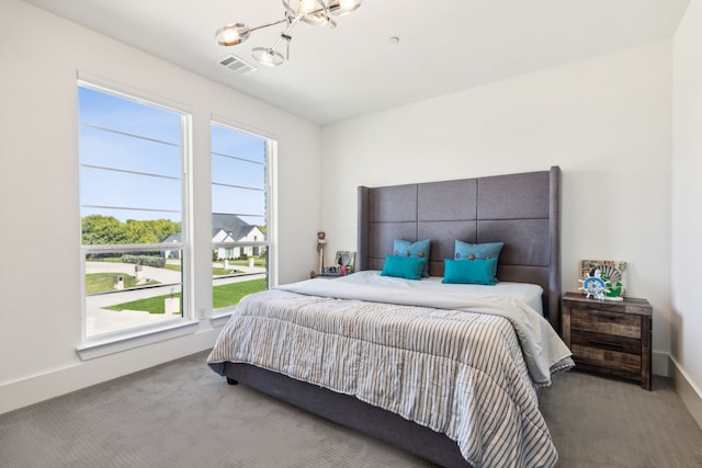 bedroom with a notable chandelier and carpet