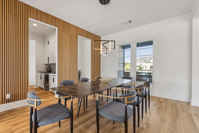 dining area featuring light hardwood / wood-style flooring and beverage cooler