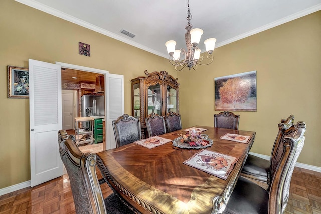 dining area featuring visible vents, baseboards, a chandelier, and ornamental molding