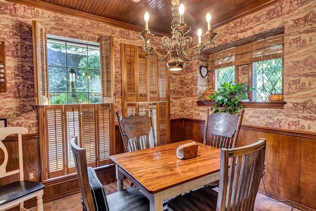 tiled dining space featuring an inviting chandelier, wood ceiling, and ornamental molding