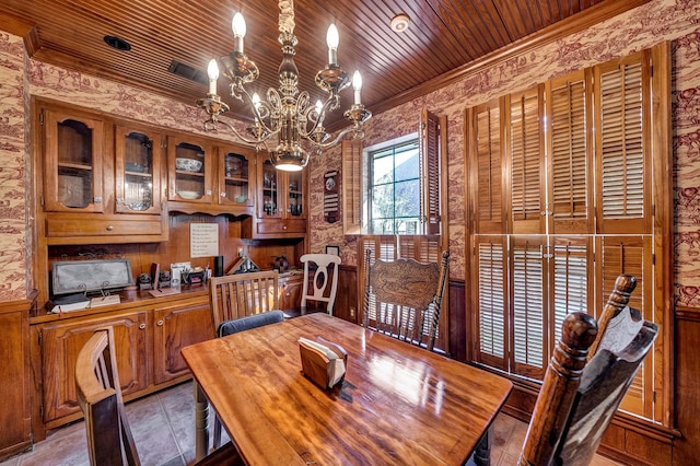 dining area featuring ornamental molding, a notable chandelier, and wood ceiling