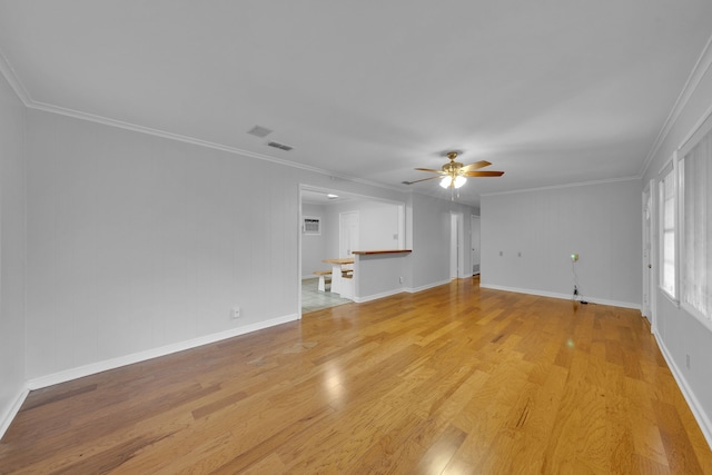 unfurnished living room featuring crown molding, ceiling fan, and light wood-type flooring