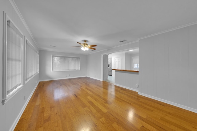 spare room with ornamental molding, light hardwood / wood-style floors, and ceiling fan