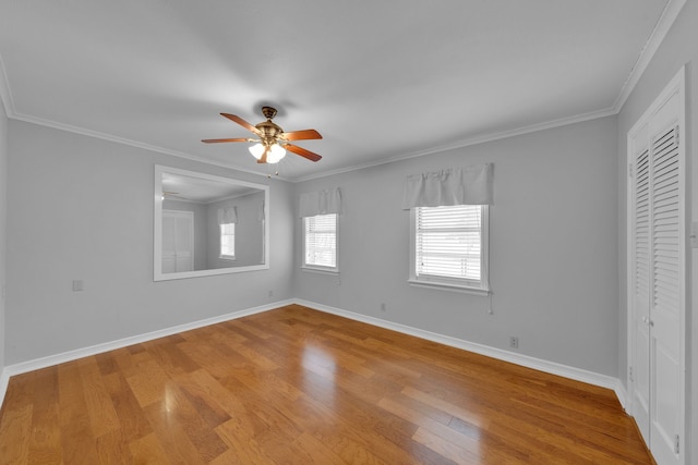 spare room with ceiling fan, ornamental molding, and light wood-type flooring