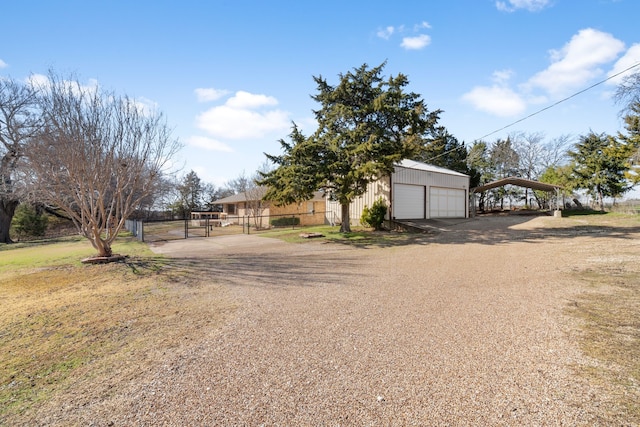 view of front of property with an outbuilding, a garage, and a carport