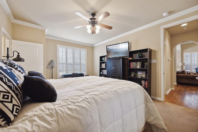 bedroom featuring crown molding, ceiling fan, and carpet flooring