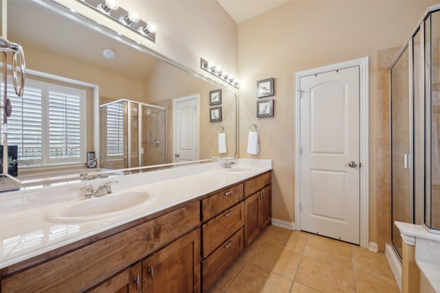 bathroom featuring vanity, a shower with door, and tile patterned flooring