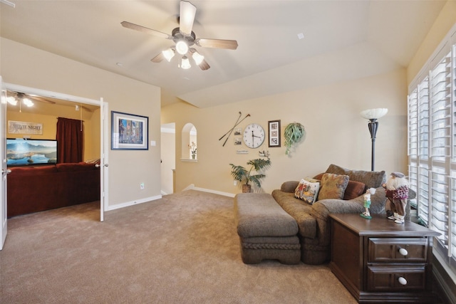 carpeted living room with ceiling fan