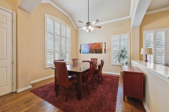 dining area with vaulted ceiling, ornamental molding, dark hardwood / wood-style floors, and ceiling fan