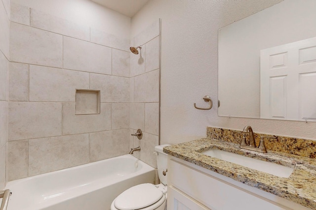 full bathroom with tiled shower / bath combo, vanity, and toilet