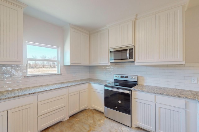 kitchen featuring stainless steel appliances, light stone countertops, and decorative backsplash