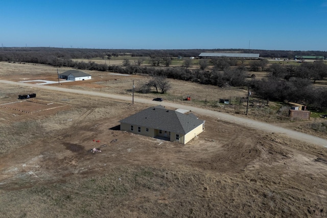 birds eye view of property with a rural view