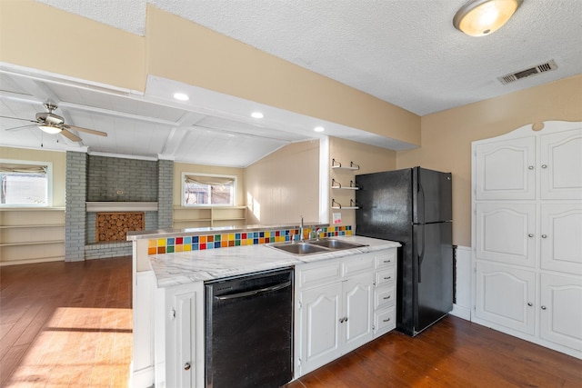 kitchen with sink, white cabinetry, kitchen peninsula, a fireplace, and black appliances