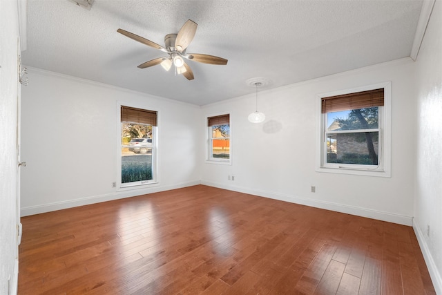 spare room with ornamental molding, hardwood / wood-style floors, and a textured ceiling