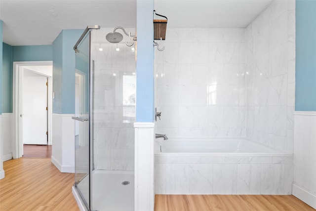 bathroom with plus walk in shower and hardwood / wood-style floors