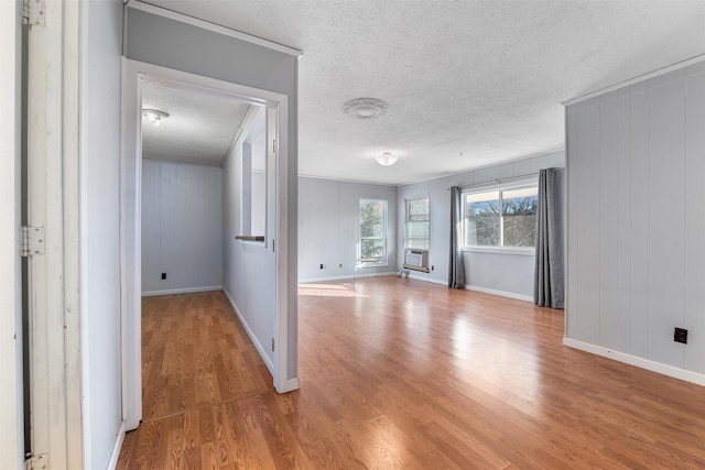 interior space with cooling unit, hardwood / wood-style floors, and a textured ceiling