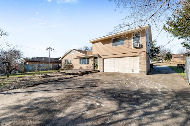 view of front of property with cooling unit and a garage