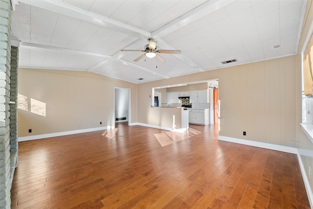 unfurnished living room with wood-type flooring, lofted ceiling with beams, and ceiling fan