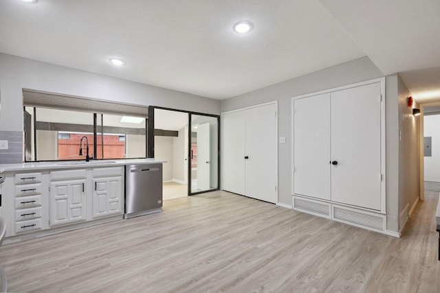 kitchen featuring white cabinetry, sink, light hardwood / wood-style floors, and dishwasher