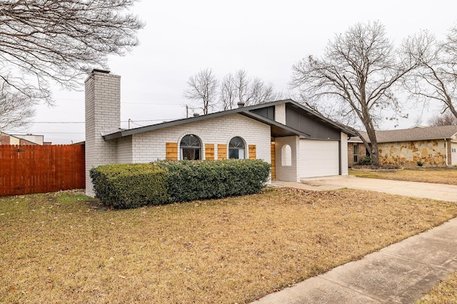 ranch-style house with a garage and a front lawn