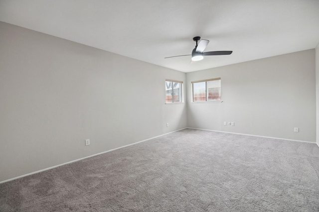 carpeted spare room with ceiling fan