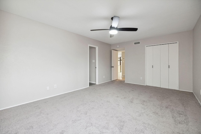 unfurnished bedroom featuring a closet, ceiling fan, and carpet