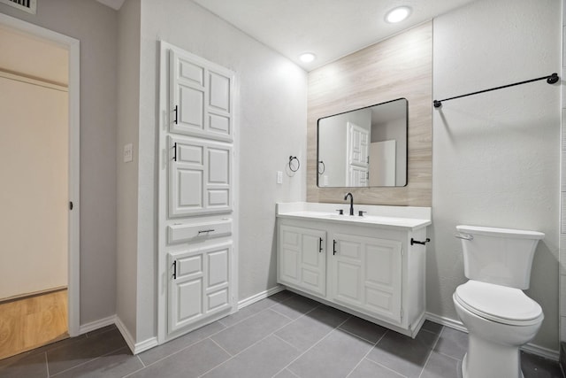 bathroom with vanity, toilet, and tile patterned flooring