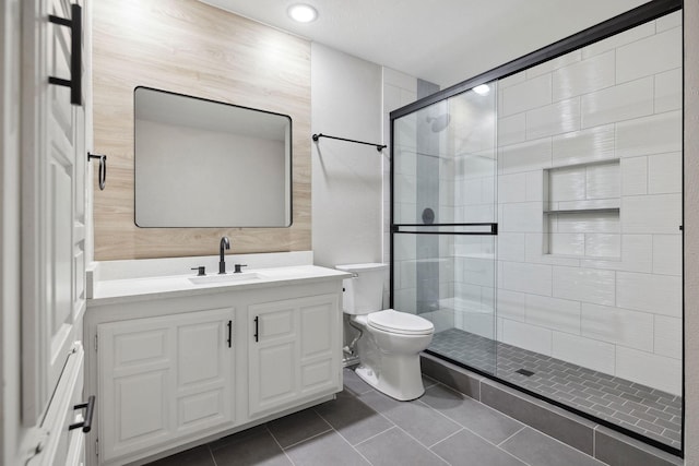 bathroom with vanity, an enclosed shower, tile patterned flooring, and toilet