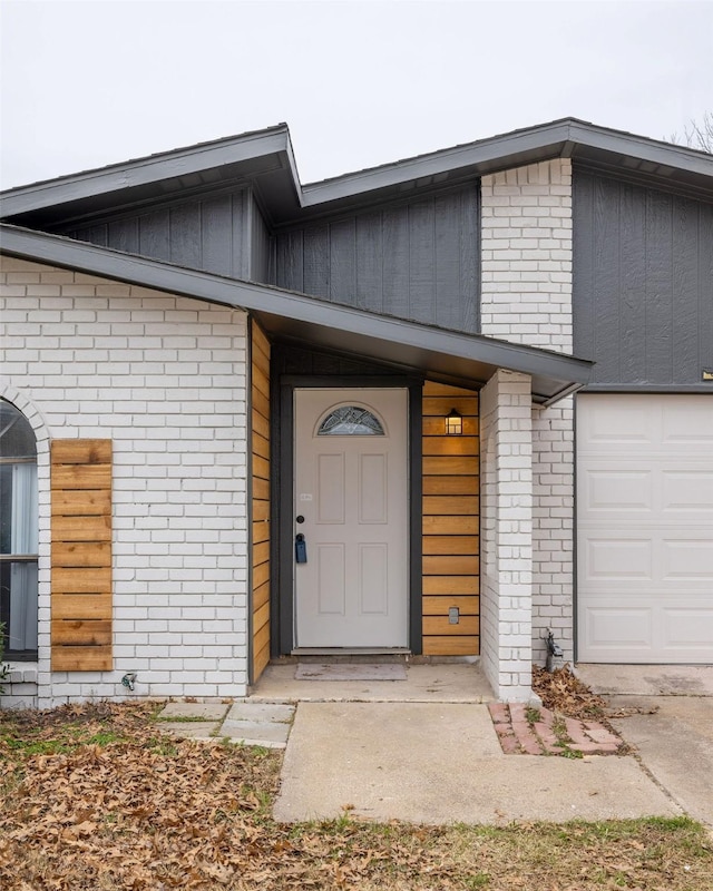 doorway to property with a garage