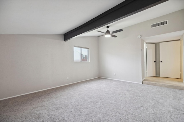 empty room with ceiling fan, light colored carpet, and lofted ceiling with beams